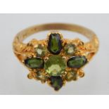 A 9ct yellow gold peridot and chrome diopside cluster ring.
