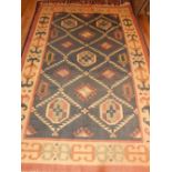 An olive ground Turkish kelim rug, decorated with geometric stepped and greek key bordered