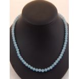 A light blue beaded necklace.