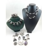 A collection of silver and white metal jewellery to include a suite of green tigers eye, Siam