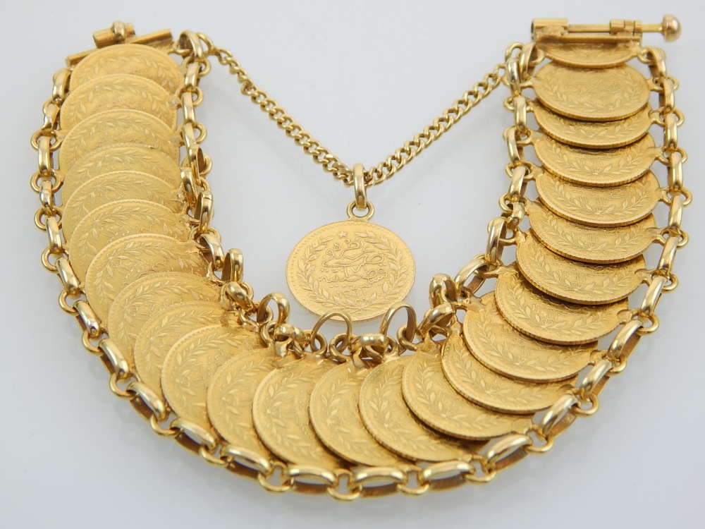 A gold bracelet, formed from and arrangement of twenty-six Middle Eastern gold coins, 59g.