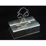 An early 20th century silver plated cigar and cigarette box, the central scroll handle over two