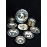 A collection of nineteen modern English silver Armada dishes, various dates and makers, many with