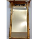 A Regency gilt wood and gesso pier mirror, the frieze with applied foliate design centred by