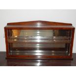 A Regency design birds eye maple wall display cabinet, with arched pediment over a glazed fall