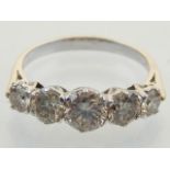 A five stone diamond dress ring, set in a white metal band, stamped 18ct.