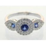 A sapphire and diamond dress ring, the central stone within a twin band flanked tear-drop shoulders,