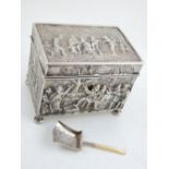 A 19th century Dutch white metal tea caddy, embossed with figures in townscape, purity marks to