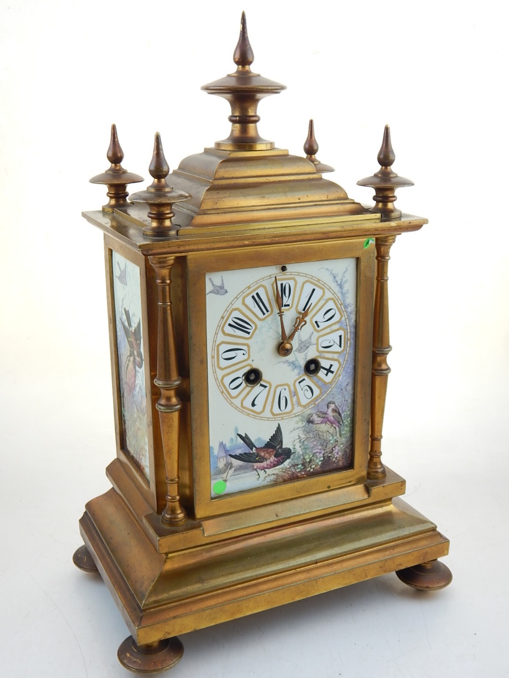 A late Victorian aesthetic movement ormolu mantel clock with eight day movement striking on a