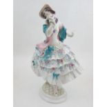 A Meissen porcelain figurine of a lady, in a floral dress, bears double crossed mark to base,