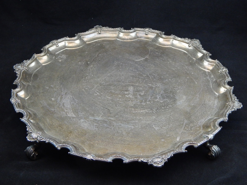 A silver salver, Adie Bros Ltd, Birmingham 1947, with shaped bead and shell rim on four acanthus