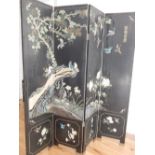 A 20th century Japanese four fold screen, comprising incised polychrome and black lacquer panes,