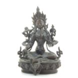 A bronze Buddhist figure, seated on a lotus blossom, H. 22cm.