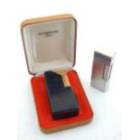 A Dunhill rollagas lighter, with an engine turned silver plated case,