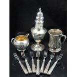 A George III silver vase shaped sugar sifter, a George V silver cream jug,