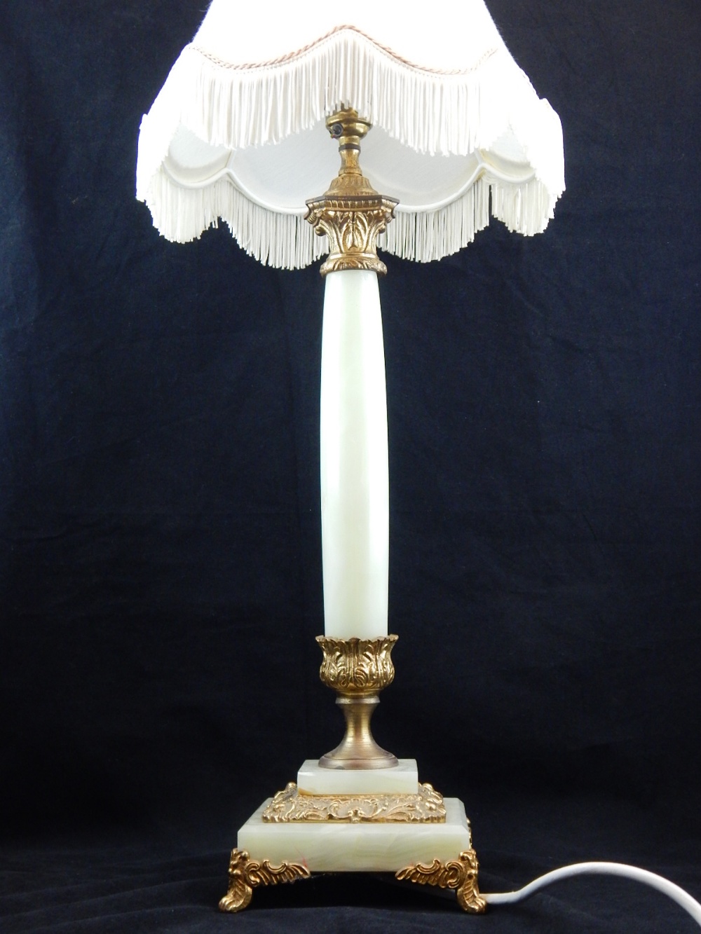 An onyx columnal table lamp, with gilt metal Corinthian mounts. H.