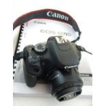 A Canon EOS 600D digital single-lens reflex camera, together with instruction manual.