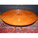 A late Victorian walnut loo table, the oval top above a quatreform turned support and splayed legs,