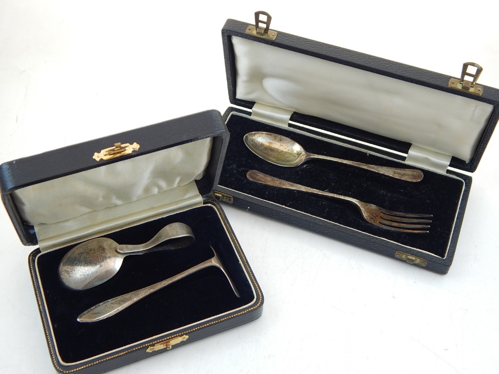 A George V silver christening fork and spoon together with a silver spoon and pusher set, both
