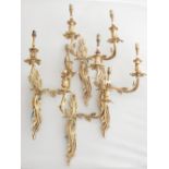 A set of four gilt metal twin branch wall lights with foliate arms, H. 52cm.