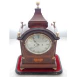 A late 19th/early 20th century mahognay mantel clock, the top with brass ball finials above a