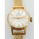 A ladies 18ct gold wristwatch on an 18ct gold mesh strap,
