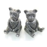 A pair of white metal salts, fashioned as seated teddys.