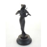 A cast bronze figure of a female violinist, raised on a circular stepped base. H. 19cm