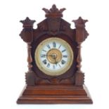 A late 19th century walnut case Ansonia wall clock, the cream chapter ring with Roman numerals. H.