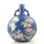 A Chinese ceramic vase of oval flagon form, polychrome decorated with birds amongst blossoming