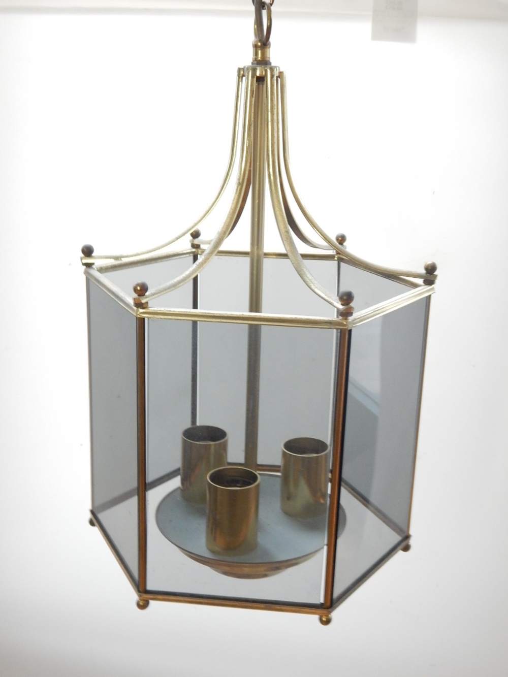 A hexagonal glazed brass hall lantern, a glass ceiling shade, a two branch brass wall light together