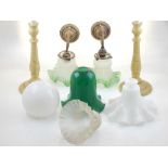 A pair of early 20th century brass wall lights with opaque green glass frill shades, together with