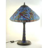 A Tiffany style table lamp, the coloured leaded glass shade decorated with dragonflies H 54cm