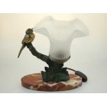 A 1950's bronzed parcel gilt spelter table lamp, cast with a bird on a branch beside an opaque glass