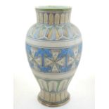 A 19th century Indian polychrome painted pottery vase, decorated with geometric bands. H. 30cm