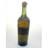 An early 20th century bottle of absinthe, the bottle with impressed mark 'Brun-Perod' and bearing