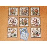 A harlequin set of eight Victorian printed pottery tiles decorated with roses, butterflies and