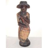 A carved hardwood polychrome figure of a Caribbean drummer, H. 80cm.
