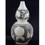 A Chinese double gourd pottery vase, decorated with babies, flowers and birds on a cross-hatched