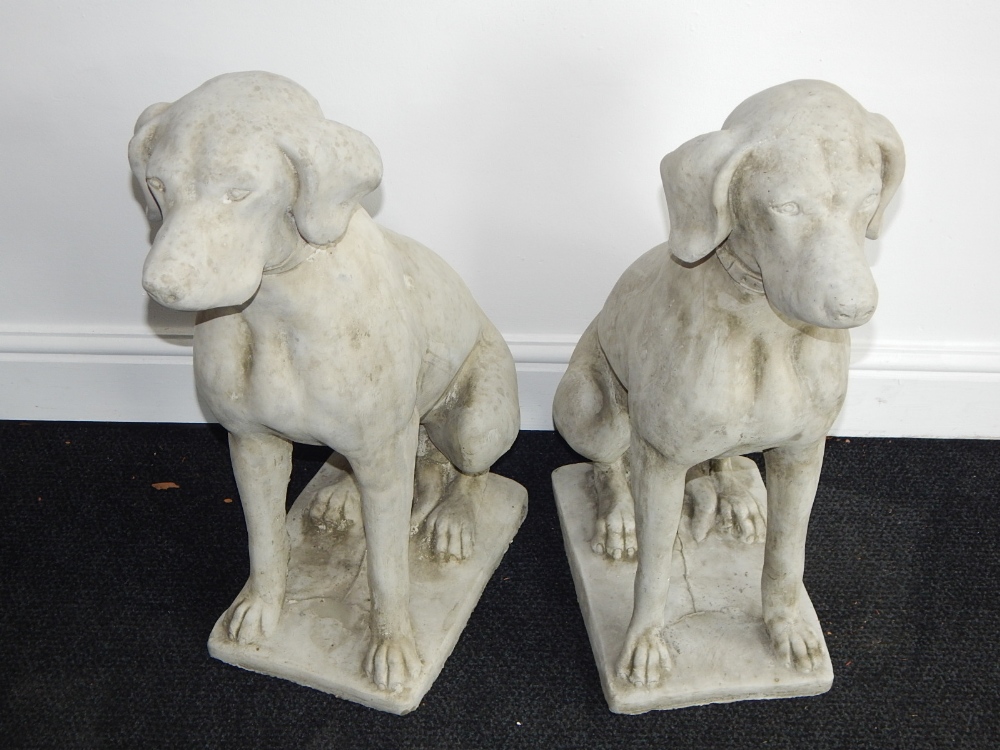 A pair of reconstituted stone dogs, seated. H. 71cm (2)