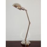 A large nickel plated adjustable desk lamp, raised on circular stepped base. H. 68cm