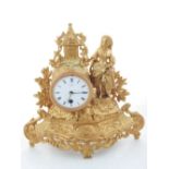 An early 20th century French gilt mantel timepiece, drum movement, white enamel dial with Romn