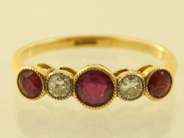 An 18ct yellow gold rubover diamond and ruby set ring. - Image 2 of 3