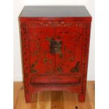 A Chinese black and scarlet two door side cabinet, landscape decorated on square legs. H.