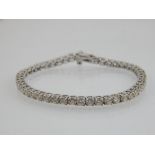 A 14ct white gold and diamond tennis bracelet, diamonds of 5.5ct combined.