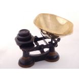 A pair of early 20th century balance scales, cast iron painted black and gilt details,