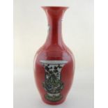 A Chinese red ground baluster vase with everted rim, decorated with vases,