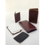 A Cartier leather wallet, card case and notepad,