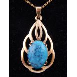 A 9ct yellow gold and turquoise pendant of leaf design, suspended on a 9ct gold chain.