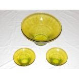 A large uranium coloured art glass bowl, D. 36cm, together with two similar smaller examples, (3).